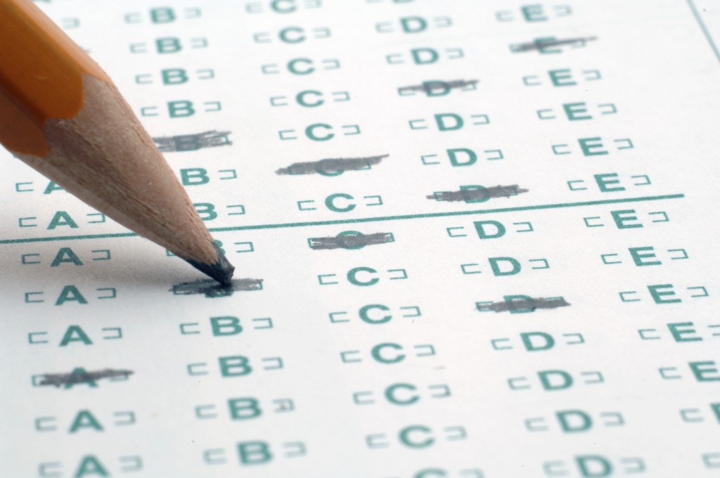 Why is there a ongoing debate over the use of SAT scores in college admissions?